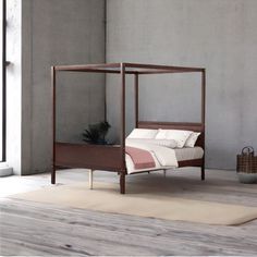 a bed sitting on top of a wooden floor next to a window