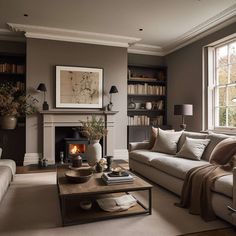 a living room filled with furniture and a fire place in the middle of a room