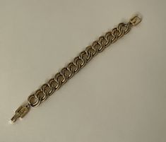 "Givenchy gold tone link chain bracelet  approximately - 8\" L with clasp x 5/8\" w.  Good vintage condition  marked: copyright symbol Givenchy  08/16/23 1428" Gold-tone Chain Link Bracelets, Gold Bracelet With Rectangular Links, Vintage Gold Bracelet With Chain, Gold-tone Chunky Chain Bracelet, Metal Link Bracelet With Chain Strap, Formal Cuban Link Chunky Chain Bracelet, Formal Chunky Chain Bracelet, Gold-tone Link Metal Bracelet, Gold-tone Metal Link Bracelet