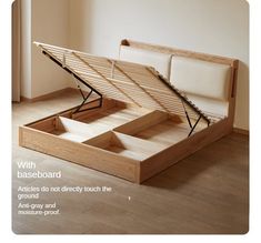 an open bed frame sitting on top of a hard wood floor