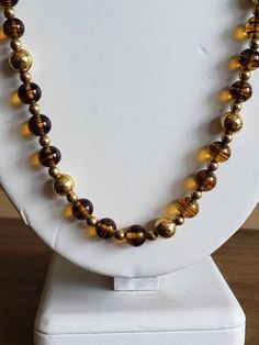 This is a vintage Napier, gold tone metal beads and glass beads necklace. There is a bit of the chain that doesn't have beads on it, as you can see in images. The beads can move on the necklace, slightly. This measures 25.25 inches across. Don't forget to stop in at my other Etsy shop... http://www.etsy.com/shop/xtdesigns. Follow me on Twitter at... MyYiayiaHadThat@MyYiayiaHadThat. If you have a wish list or are looking for something specific, please ask. I may have exactly what you are looking Vintage Polished Gold Beads, Vintage Gold Polished Beads, Vintage Large Gold Beads, Vintage Gold Jewelry With Large Beads, Large Gold Beads For Costume Jewelry, Gold Metal Beaded Necklaces With Large Beads, Gold Metal Beaded Necklace With Large Beads, Gold Beaded Necklace With Large Metal Beads, Gold Metal Necklace With Large Beads