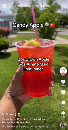 a person holding up a drink in front of their face with the caption, candy apple