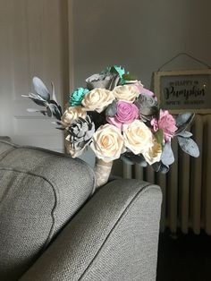 a bouquet of flowers sitting on top of a couch next to a radiator