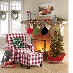 a living room decorated for christmas with stockings on the fireplace