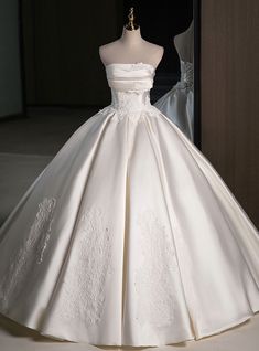 a white wedding dress is on display in front of a mannequin's dummy