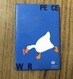 a book with an image of a duck on it's cover sitting on top of a wooden table