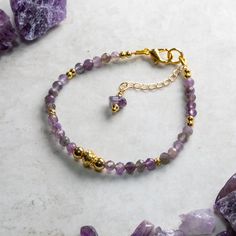 Elegant Amethyst and gold bracelet hand crafted with care and attention to detail using AA 4mm faceted Amethyst beads, gold fill accent beads and a gold plated simulated twisted wire central bead. The bracelet is constructed using quality 19 strand nylon coated beading wire which is both flexible for a comfortable wear and extremely durable. The bracelet measures 17.5cm and is fastened with a gold plated lobster claw clasp and a 30mm extension chain for an adjustable fit up to 20 cm. Amethyst is Spiritual Amethyst Gold Bracelets, Spiritual Charm Bracelet With Faceted Beads As A Gift, Faceted Gold Crystal Bracelet As Gift, Gold Crystal Bracelet With Natural Stones For Healing, Gold Amethyst Bracelets For Healing, Gold Bracelets With Round Amethyst Beads, Elegant Gold Crystal Bracelet For Meditation, Gold Amethyst Beaded Bracelets For Jewelry Making, Gold Crystal Bracelet With Gemstone Beads As Gift