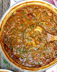 a large pot filled with food on top of a wooden table