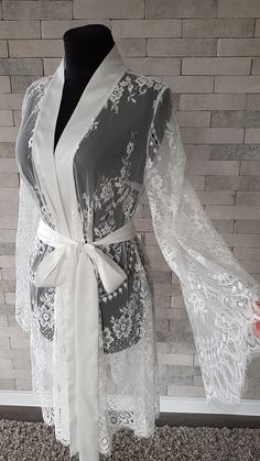 Off-white luxurious wedding robe, to add a perfect touch to your perfect and unique day. Only high quality fabrics and high finishing used for making the robe as neat as it can be. Please find the wedding robes collection here https://www.etsy.com/shop/LidiasBoutiqueDesign?ref=seller-platform-mcnav&section_id=25023222. For wedding dresses, please access https://www.etsy.com/shop/LidiasBoutiqueDesign?ref=seller-platform-mcnav§ion_id=23157290. For wedding tops and boleros, please access https: Feminine Lace Wedding Dress With Lace Sleeves, Lace Nightgown For Wedding Night, Elegant Lace Dress For Bridal Shower, Elegant Bridesmaid Lace Dress With Delicate Details, Elegant Long Fitted Sleepwear, Fitted Long Elegant Sleepwear, Elegant Nightgown With Delicate Lace For Wedding Night, Elegant Lace Nightgown, White Lace Nightgown For Wedding Night