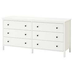 a white dresser with black knobs and drawers