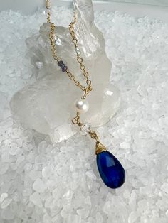 Looking for something unique for that Kyanite Lover? Do you love Herkimer Diamonds? This is a beautiful design that incorporates both, with accents of faceted Blue Topaz, Iolite & Blue Quartz.Gorgeous 9 X 15mm Blue Kyanite pendant is hand wrapped to a Herkimer Diamond & Beautiful Freshwater Pearl for a stunning drop pendant. The Kyanite gemstone has striations and shades of blue, and with the faceting, make this pendant stunning!The chain is comprised of stations of beautiful Herkimer Diamonds, Sapphire Gemstone Drop Necklaces, Sapphire Drop Gemstone Necklace, Sapphire Drop Necklace With Gemstone, Sapphire Teardrop Jewelry With Gemstone Accents, Blue Briolette Necklace For Anniversary, Blue Topaz Briolette Jewelry Gift, Blue Topaz Briolette Jewelry For Gifts, Sapphire Briolette Jewelry For Anniversary, Sapphire Drop Gemstone Jewelry