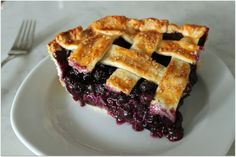 a slice of blueberry pie on a white plate