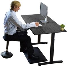 a man sitting at a desk using a computer