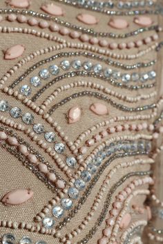 the back of a dress with beading and sequins on it's side