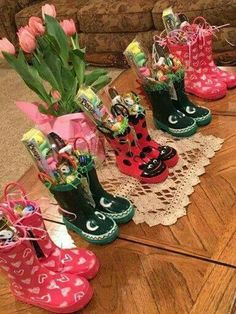 four pairs of rain boots with flowers in them