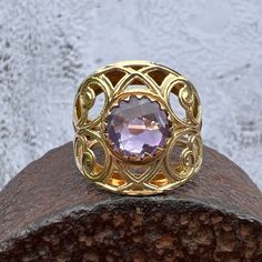 Gorgeous Checkerboard Cut Round Amethyst set in a Wide 14K Yellow Gold Filagree Ring US Size 5 Amethyst approximately 2 ct. Widest point measures approximately 18.1 mm. Back of the shank tapers down to 3.5 mm, approximately. Stamped 14k RL ITALY Weighs approximately 4.1 grams.  Amethyst is the birthstone for February. Heirloom Yellow Gold Amethyst Ring With Accent Stones, Heirloom 14k Gold Amethyst Ring With Accent Stones, Gold Amethyst Gemstones With Accent Stones, Victorian Gold Amethyst Ring In 14k Gold, Fine Jewelry Amethyst Gold Ring, 14k Stamped Amethyst Ring Fine Jewelry, Fine Jewelry Gold Amethyst Ring, Fine Jewelry Gold Ring With Amethyst, Heirloom 14k Stamped Amethyst Jewelry