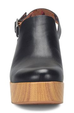 An adjustable slingback elevates this retro-inspired clog elevated by a bold platform. 3 1/2" heel; 1 1/4" platform Synthetic upper/textile lining/rubber sole Imported Black Platform Clogs With Wedge Heel, Black Modern Chunky Platform Clogs, Black High Heel Platform Clogs, Black Synthetic Clogs With Buckle Closure, Leather Clogs With Chunky Platform And Open Heel, Trendy Leather Clogs With Chunky Platform, Chic Black Clogs With Heel Strap, Chic Black Platform Clogs, Trendy Leather Clogs With Reinforced Heel