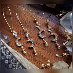 Listing is for ONE (1) pair of earrings.  These beautiful crescent moon earrings are crafted with gold plated pyrite beads, gold plated crystal moon charms, glass diamond shaped charms, Czech faceted glass beads, & matching hoops + your preference of hook style. ▪︎▪︎▪︎▪︎▪︎ * (Quantity: ONE (1) pair each - Though others may be recreated similarly, it may take longer depending on supply inventory, please contact me.) * Please note that as each product is handmade, each one will be unique and one o Gold Crescent Spiritual Earrings, Gold Half Moon Celestial Earrings, Gold Crescent Earrings With Moon Phase Detail, Gold Moon-shaped Celestial Crystal Earrings, Celestial Gold Moon-shaped Crystal Earrings, Gold Celestial Crystal Earrings With Moon Charm, Gold Celestial Crystal Earrings Nickel Free, Gold Celestial Crystal Earrings Nickel-free, Celestial Gold Crystal Earrings Nickel Free