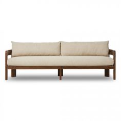 an image of a couch with pillows on the top and bottom part of it, in front of a white background