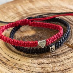 "Celebrate your unique bond with these beautifully crafted Couple Bracelets. Perfect for anniversaries, special occasions, or just as a token of your love. Features: Adjustable Fit: Both bracelets are adjustable. The red one can close up to almost 6\", while the black one adjusts to nearly 6.5\", ensuring a snug fit for most wrist sizes. Personalized Initials: Add a personal touch with engraved initials. The red color bracelet showcases your chosen initial, while the black bracelet features a st Adjustable Black Friendship Bracelets For Valentine's Day, Black Braided Bracelets For Valentine's Day Gift, Adjustable Black Bracelets For Valentine's Day, Black Braided Bracelet For Valentine's Day Gift, Handmade Black Friendship Bracelets For Valentine's Day, Black Friendship Bracelet For Valentine's Day, Handmade Couples Bracelets As Gift, Adjustable Couples Friendship Bracelets For Valentine's Day, Handmade Couples' Bracelets As Gift