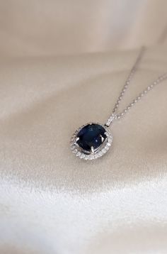 Blue Sapphire Oval Cut Pendant with a Diamond Halo. Pendant is by Diamond and Gold Warehouse in Dallas, Texas. Dazzling Blue Necklace With Brilliant Cut, Elegant Blue Diamond Pendant Necklace, Blue Luxury Diamond Necklace For Anniversary, Blue Diamond Necklace For Formal Occasions, Luxury Blue Diamond Necklace For Anniversary, Luxury Blue Diamond Necklace For Formal Occasions, Blue Diamond Necklace For Wedding, Elegant Blue Diamond Necklace For Wedding, Luxury Blue Diamond Pendant Necklace