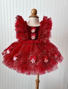 This is made in a 9-12 month size and is ready to ship.  This listing is for the Red Holiday Peppermint Dress. It is made with a red, velvet stretchy fabric. The ruffles and skirt are made with red tulle and red embroidered lace. 3D peppermints have also  been added to this dress.  All of my items will be mailed in a box to ensure safety of the romper.   Size Chart:                                            HEIGHT                   WEIGHT Preemie(Newborn):    up to 21 inches.         5-8 lbs. 0-3 Months:                 21-24 inches.             8-12 lbs. 3-6 Months:                 24-26 inches.            12-16 lbs. 6-9 Months:                 26-28 inches.            16-20 lbs. 9-12 Months:                28-30 inches.           20-24 lbs. 12-18 Months:               30-32 inches. Red Tulle Dress, Dog Sweater Crochet Pattern, Red Tutu, Red Holiday Dress, Dog Sweater Pattern, Candy Dress, Crochet Dog Sweater, Red Christmas Dress, Holiday Dress