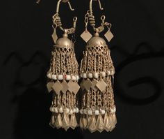 These Antique earrings were handcrafted by a kuchi member in Afghanistan ,  metal they utilized  is commonly known as  German silver or glit as they call it in Afghanistan.  These earrings are in excellent condition and ready to wear. Measurements is 10.5cm long #8E Ceremonial Dangle Earrings With Latkans, Traditional Silver Beaded Earrings For Pierced Ears, Heavy Metal Earrings For Ceremonial Occasions, Traditional Metal Beaded Drop Earrings, Handmade Traditional Silver Beaded Earrings, Traditional Handmade Silver Beaded Earrings, Vintage Dangle Chandelier Earrings For Festive Occasions, Festive Bohemian Earrings With Dangling Beads, Vintage Chandelier Dangle Earrings For Festive Occasions