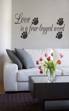 a living room with a white couch and a black chandelier on the wall