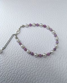 Delicate pearl bracelet, purple agate gemstone and white pearls, adjustable. This dainty pearl bracelet is simple and elegant. Glass pearls are coated in coloured lacquer to give a beautiful lustre finish. A beautiful gift for any occasion. Comes in its own gift box. Adjustable Elegant Purple Crystal Bracelet, Adjustable Crystal Bracelet With Pearl Charm, Handmade Adjustable Pearl Crystal Bracelet, Purple Beaded Pearl Bracelets, Elegant Purple Adjustable Bracelets, Purple Pearl Bracelet Gift, Purple Pearl Bracelet As A Gift, Purple Pearl Bracelet With Round Beads As Gift, Elegant Purple Pearl Bracelet With Round Beads