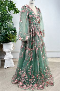 Indulge in the elegance of our Long Sleeves O Neck Pink Floral Embroidery Sage Tulle Dress. Adorned with intricate floral embroidery and crafted from delicate tulle, this dress exudes sophistication and charm. The long sleeves provide coverage while the O neck adds a touch of femininity. Perfect for special occasions and making a statement. Bust and Skirt with full lining. 100% Polyester 100% Recycled polyester lining Concealed zip at center back Imported Floral Lace Green Dress, Luxury Long Dress With Floral Embroidery, Luxury Floor-length Embroidered Dress For Formal Occasions, Luxury Lavender Dress With Intricate Embroidery, Formal Dresses Long Embroidered, Green Wedding Gown With Floral Applique, Green Floral Applique Wedding Gown, Floor-length Floral Applique Gown For Banquet, Elegant Green Gown With Floral Embroidery