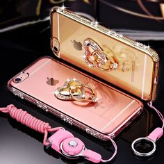 an iphone case with a pink cord attached to it and a pair of scissors on top