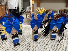 three small wooden toy soldiers with blue bows on top of a table covered in other decorations