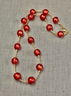 "Perfect for your holiday party this red Murano glass beaded necklace will add luxury and style to your outfit! The glass artisan beads have a subtle texture to them that adds to their personality and charm. Each handmade bead has genuine 14k gold foil within it. The necklace measures 19.5 inches with gold fill lobster claw clasp. A perfect gift for any occasion and arrives in a standard gift box. * Matching earrings are available at this link: https://www.etsy.com/listing/1596931806/murano-glas Red Round Beads Jewelry For Christmas, Red Jewelry For Holiday Jewelry Making, Handmade Red Beaded Necklaces For Celebration, Red Beaded Jewelry For Holiday, Red Round Bead Necklaces For Christmas, Red Christmas Necklaces For Jewelry Making, Elegant Red Beaded Necklace With Colorful Beads, Red Single Strand Necklace For Gift, Elegant Red Necklace With Polished Beads