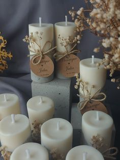 some white candles are sitting next to each other