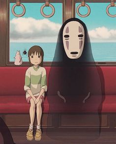 a person sitting on a red couch in front of a window with a ghost mask