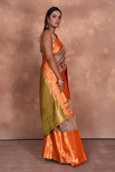 Beautiful beige striped Kanjeevaram Kora saree with orange zari border is perfect for light festive occasions. It comes with a matching blouse piece. Shop Indian sarees in USA from Pure Elegance. Disclaimer: The shown stitched blouse on the model is for display purpose only. The saree comes with a matching blouse piece and finished with fall and piko. Traditional Orange Banarasi Silk Pre-draped Saree, Traditional Orange Pre-draped Saree With Zari Weaving, Festive Designer Orange Pre-draped Saree, Orange Pre-draped Designer Saree For Festive Occasions, Festive Orange Pre-draped Saree With Zari Weaving, Festive Orange Pre-draped Saree For Designer Wear, Orange Banarasi Silk Pre-draped Saree For Diwali, Designer Wear Orange Pre-draped Saree With Traditional Drape, Designer Wear Orange Pre-draped Saree