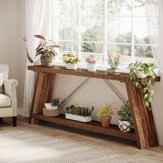 a wooden table with potted plants on it in front of a white chair and window