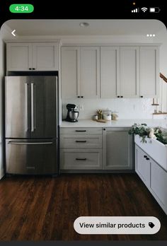 a kitchen with wooden floors and white cabinets