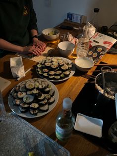 a person preparing sushi at a kitchen table