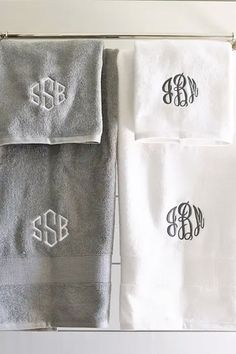 three monogrammed towels hanging on a towel rack