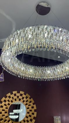 a crystal chandelier hanging from the ceiling in a room with mirrors and lights