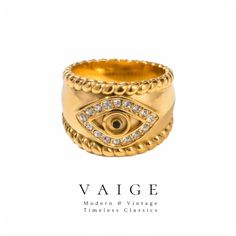 VAIGE Gold Zirconia Devil Eye Ring Elevate your accessory game with the stunning VAIGE Gold Zirconia Devil Eye Ring. This exquisite ring is not just a piece of jewelry; it's a statement of style and sophistication. Crafted from durable stainless steel, this ring is designed to withstand the test of time while maintaining its luxurious appearance. The shimmering gold finish beautifully complements the eye-catching zirconia detailing, creating a striking contrast that draws attention. Key Features 14k Gold Diamond Ring With Diamond Eyes, Gold Rings With Diamond Eyes For Promise, Gold Rings With Diamond Eyes For Anniversary, Yellow Gold Rings With Diamond Eyes For Anniversary, Gold Promise Ring With Diamond Eyes, Elegant Gold Rings With Diamond Eyes, Devil Eye, Steel Flowers, Eye Ring