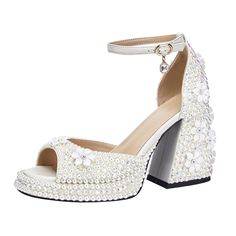 a women's white high heeled shoe with pearls