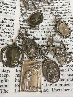 Vintage religious catholic non sterling charm medals in a sterling chain necklace circa 1960's. This necklace is 20 inches in total length and adjustable with 7 religious medals charms hanging nicely namely st Francis of Assisi, sacred heart, immaculate Concepcion, st ann, virgin of Carmel, st Chiara, all medal charms are not sterling silver except for the chain which is 925. This is a very nice religious necklace that is also a statement and fashion piece of jewelry. One of a kind. Vintage Silver Necklace With Dangling Charms, Vintage Sterling Silver Necklaces With Dangling Charms, Vintage Sterling Silver Necklace With Dangling Charms, Vintage Sterling Silver Miraculous Medal Jewelry, Vintage Sterling Silver Miraculous Medal, Vintage Silver Medallion Charm Necklace, Silver Medallion Charm Necklaces With Vintage Charm, Vintage Silver Necklace With Miraculous Medal, Silver Vintage Charm Necklace