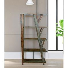 a tall wooden shelf sitting in front of a window next to a potted plant