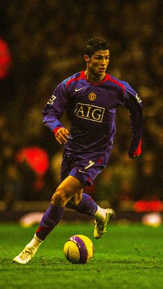 a soccer player is running with the ball in his hand as he prepares to kick it