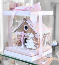 a glass case with a gingerbread house in it