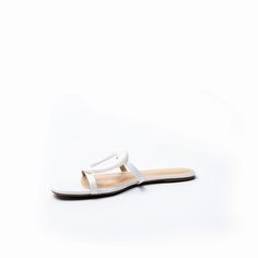 The Melissa sandal is defined by an oversized cutout metal ornament adding glamour to this leather slip on. Made from ultra-soft leather with a molded foam insole, the flat is effortlessly comfortable, and looks just as amazing with pants as it does with dresses. Color: White Leather Upper/Leather Lining/Manmade sole Flat slip on sandal cutout ornament detail 4 mm padded footbed Elegant Open Toe Slip-ons For Summer, Elegant White Leather Slides, Elegant Summer Slip-ons With Cushioned Footbed, Elegant White Flat Heel Slippers, Elegant White Flat-heel Slippers, Elegant White Slip-on Slippers, Elegant White Slides For Spring, Elegant Slip-on Open Toe Slippers, White Elegant Synthetic Slippers