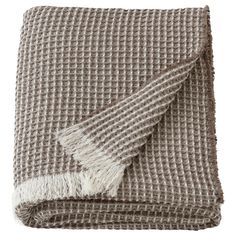 a brown and white checkered blanket with fringes on the edges, folded up