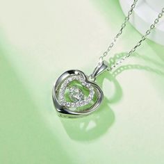 An eye-catching round moissanite dances with ease at the center of this appealing women's necklace, expressing your unstoppable love. Additional round gem set in sterling silver frame the center. Features Moissanite was originally found in meteorites(Chemical name: Silicon Carbide). It was first discovered in 1893, while a scientist was examining meteor samples from a crater in Arizona. After many years, the experts has been recreated moissanite in the laboratory, that make the gemstone with fri